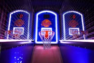 A colorful indoor arcade game showcasing basketball hoops in a vibrant setting, perfect for entertainment venues.